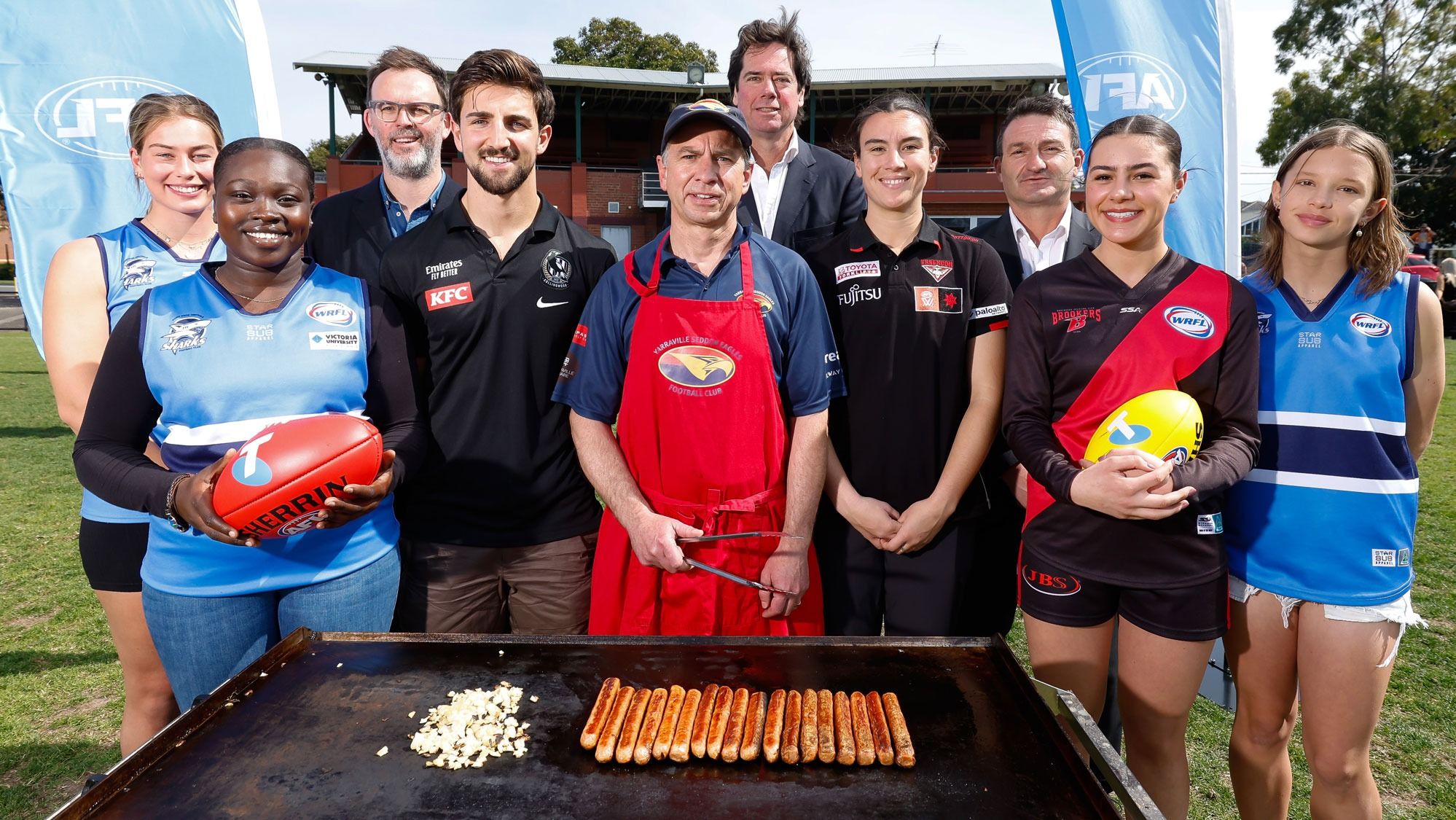 Members of the Western Region Football League are joined by (L-R) Telstra's Brent Smart, Collingwood's Josh Daicos, AFL CEO Gillon McLachlan, Essendon's Bonnie Toogood and AFL's Rob Auld